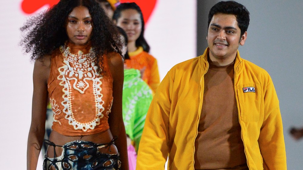 L’Oréal Professionnel Creative Award winner Dhruv Bandil walking next to one of the models featured in his collection.
