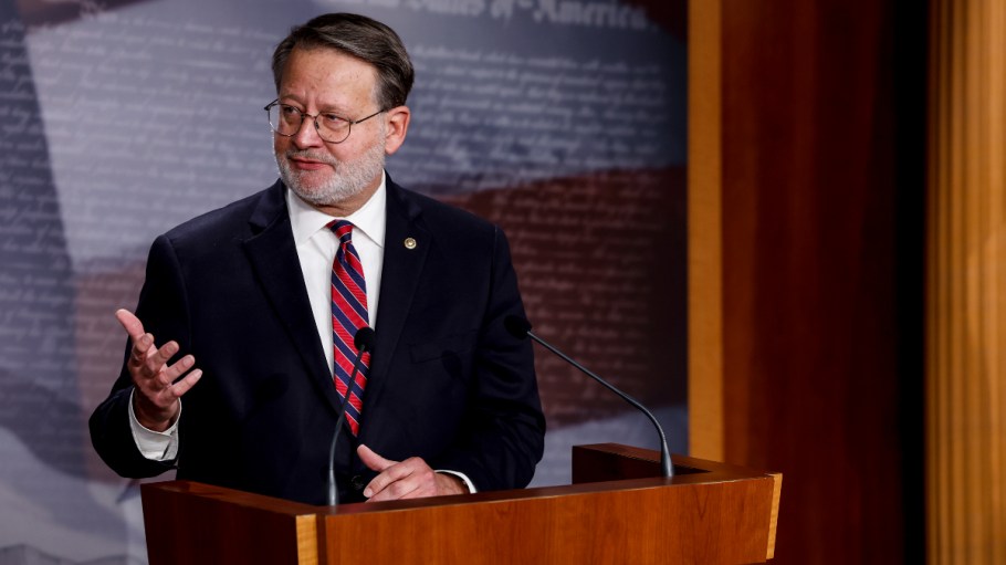 Senator Gary Peters (D-MI) stands at a podium.
