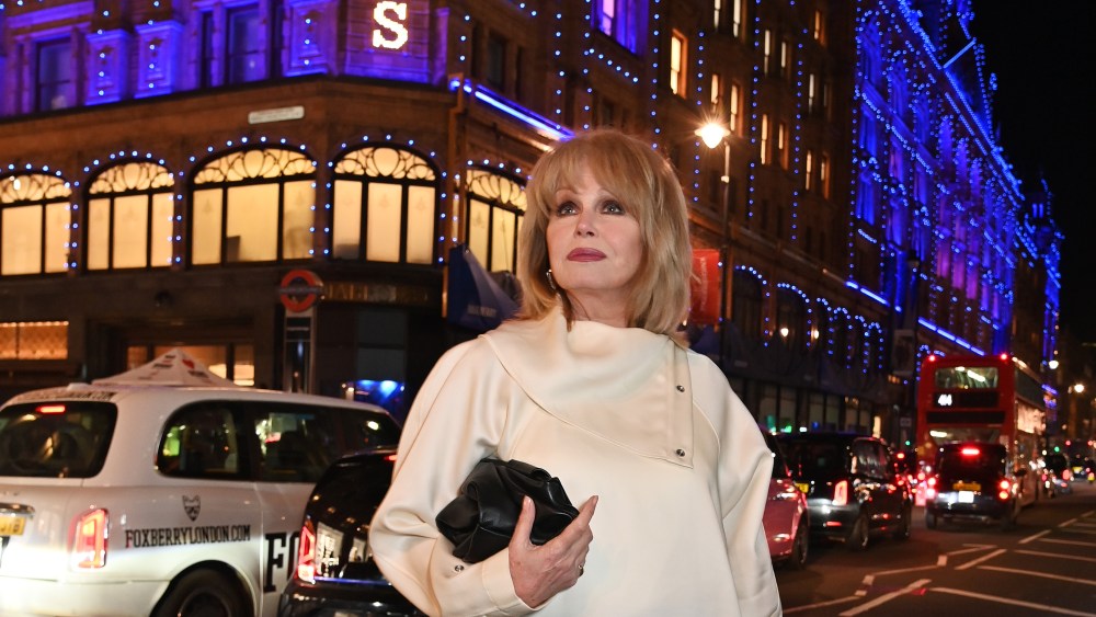 Joanna Lumley in front of Harrods lit with Burberry's signature blue.