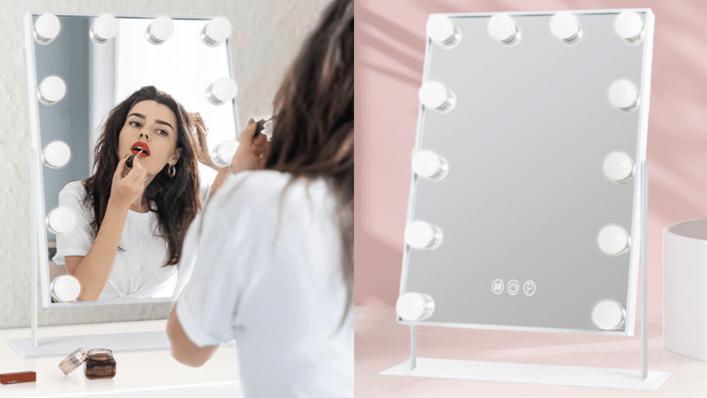 brunette woman applying red lipstick in front of a vanity mirror; vanity mirror with light bulbs in front of pink bathroom counter background