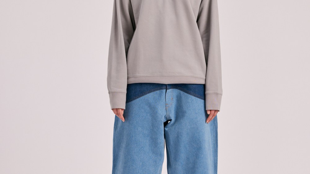 Fashion's shift to denim and looser fits could impact athletic apparel retailers such as Lululemon, Jefferies analyst Randal J. Konik said.