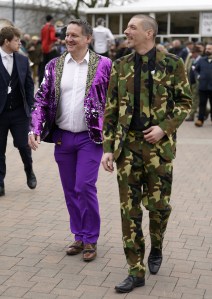 Racegoers Ash Robinson (left) and Paul Norfolk wearing colourful suits on day two of the 2024 Cheltenham Festival at Cheltenham Racecourse. Picture date: Wednesday March 13, 2024. (Photo by Andrew Matthews/PA Images via Getty Images)
