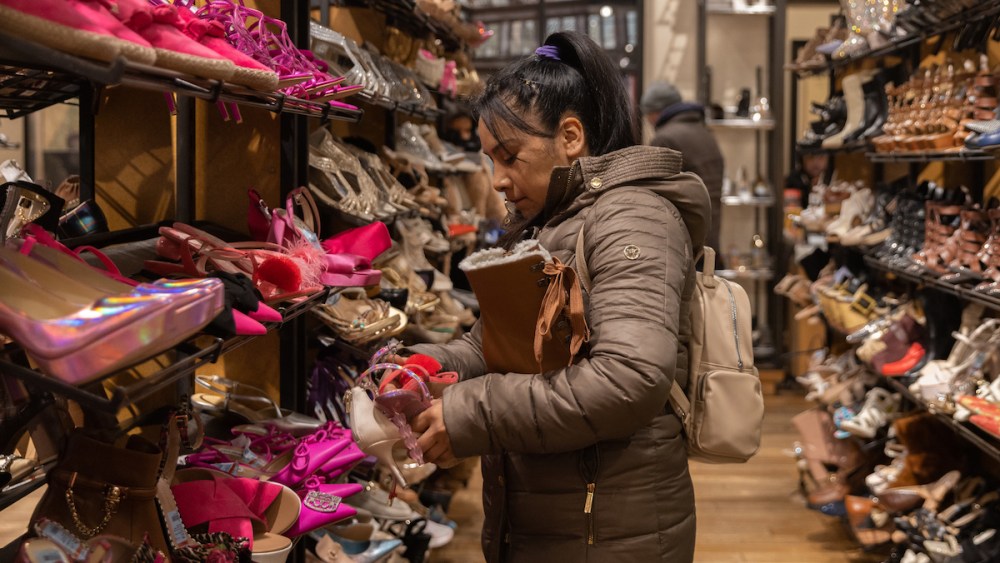 NEW YORK, NEW YORK - DECEMBER 23: A shopper holds shoes at Macy's store in Herald Square on December 23, 2023 in New York City. (Photo by Jeenah Moon/Getty Images)