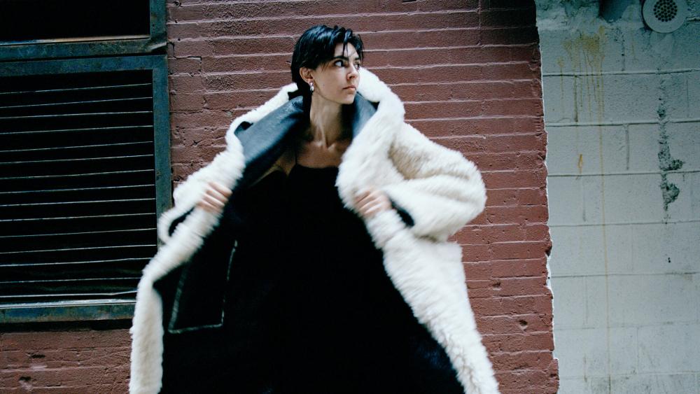 A look from Kuzyk via Moda Operandi. woman in white coat