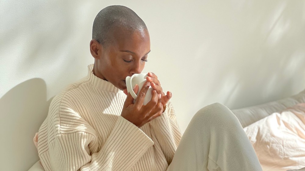 Woman drinking Mud/Wtr coffee alternative.