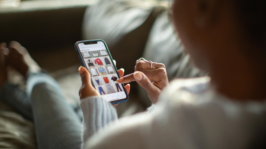 Woman online shops on a mobile phone.