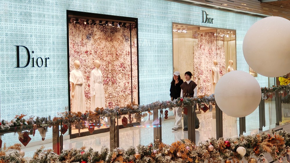 Shoppers walking past a Dior store in Shanghai, China.