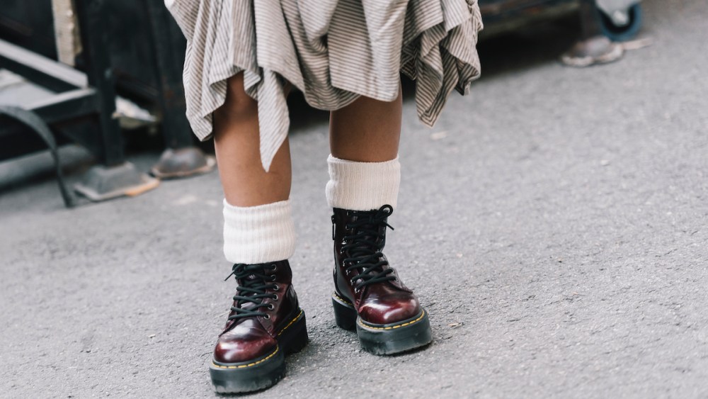 An attendee wears Dr Martens boots with a gathered skirt and cream blazer at Melbourne Fashion Festival 2024 on March 07, 2024 in Melbourne, Australia. (Photo by Naomi Rahim/WireImage)