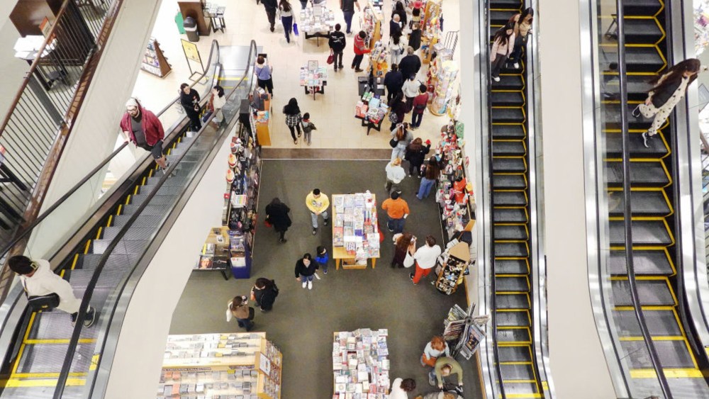 shoppers on mall escalators