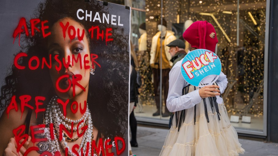 A group of capitalist activists are performing and giving away clothes during Black Friday in Barcelona on Nov. 24, 2023. They are protesting against large fast fashion commercial brands like Shein, which now produce twice as many clothes as they did two decades ago through processes that pollute and exploit people.