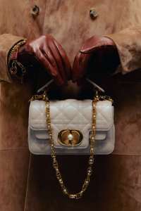 Dior mini Dior Jolie top-handle bag; Loewe cashmere suede coat; Carolina Amato gloves; Loro Piana charm bracelet.