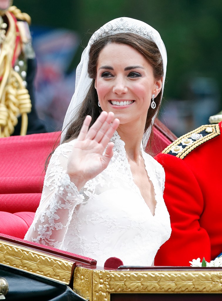 LONDON, UNITED KINGDOM - APRIL 29: (EMBARGOED FOR PUBLICATION IN UK NEWSPAPERS UNTIL 24 HOURS AFTER CREATE DATE AND TIME) Catherine, Duchess of Cambridge travels down The Mall, on route to Buckingham Palace, in the 1902 State Landau horse drawn carriage following her and Prince William, Duke of Cambridge's wedding ceremony at Westminster Abbey on April 29, 2011 in London, England. The marriage of Prince William, the second in line to the British throne to Catherine Middleton was led by the Archbishop of Canterbury and was attended by 1900 guests, including foreign Royal family members and heads of state. Thousands of well-wishers from around the world have also flocked to London to witness the spectacle and pageantry of the Royal Wedding. (Photo by Max Mumby/Indigo/Getty Images)