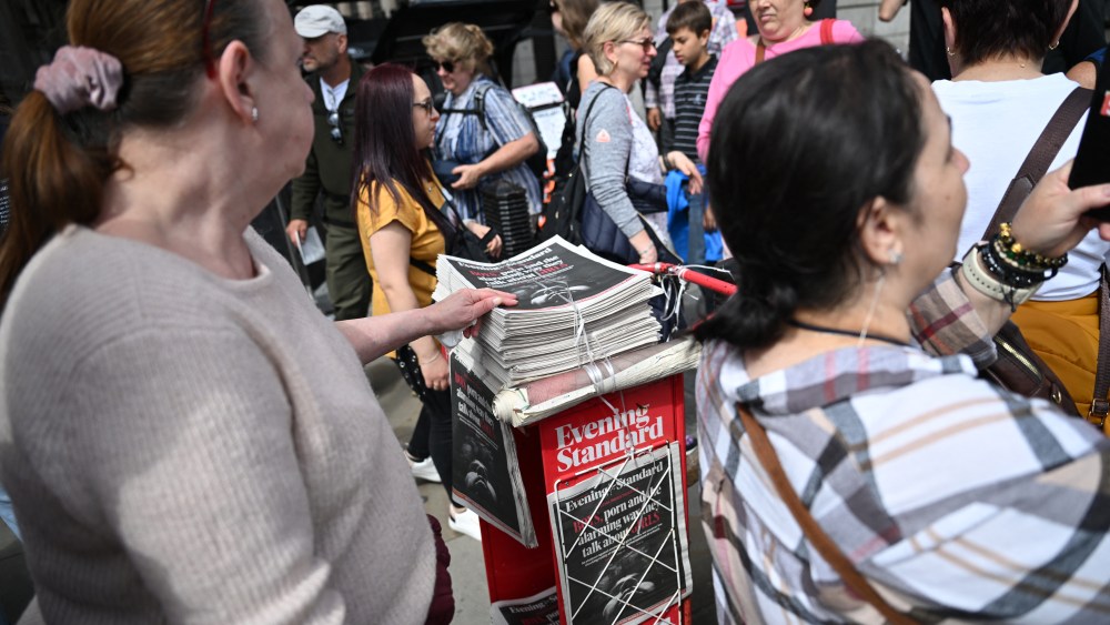 Passersby pick up copies of the free London newspaper the Evening Standard in central London.