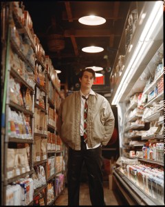 Nicholas Galitzine wears Y/Project polyester bomber jacket; Brooks Brothers cotton shirt; United Colors of Benetton leather pants; Reebok sneakers.