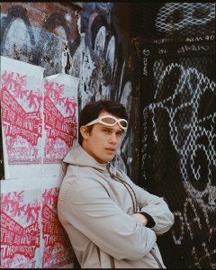Nicholas Galitzine photographed in Bushwick for April 30, 2024. Galitzine wears Miu Miu tech canvas jacket; Port Tanger sunglasses.