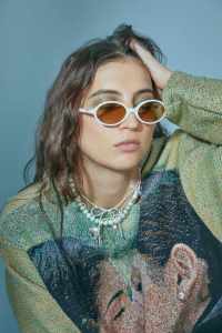 Knitwrth cotton jumper. Miu Miu sunglasses. Mudd Pearl necklaces; Kara Yoo necklace.