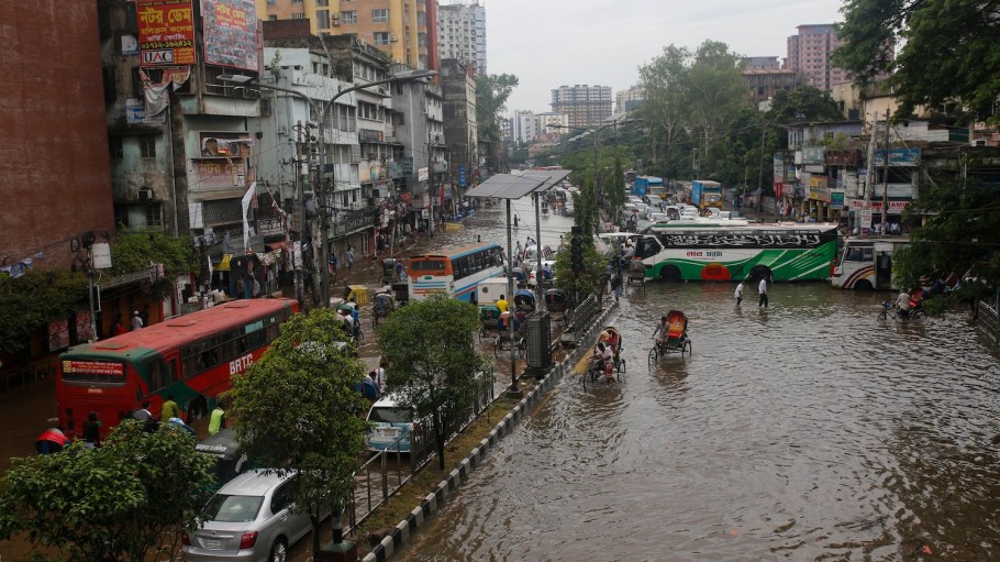 Vehicles and rickshaws are making their way through a waterlogged street in Dhaka, Bangladesh, on May 28, 2024, after heavy rainfall following the landfall of Cyclone Remal.