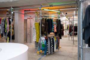 Industrial scaffolding is sparked with neon tubes in the basement streetwear zone.