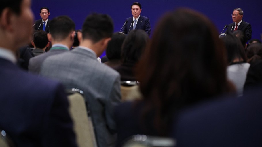South Korea's President Yoon Suk Yeol (center) speaks as Japan's Prime Minister Fumio Kishida (left) and China's Premier Li Qiang (right) listen during a joint news conference following their trilateral summit meeting in Seoul on May 27, 2024.