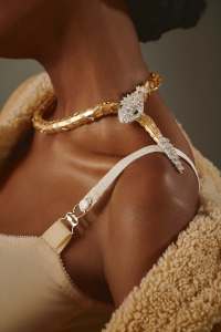 Bulgari Serpenti High Jewelry necklace in white and yellow gold set with marquise brilliant-cut diamonds, round and pear rubies and pavé-set diamonds; Tory Burch spaghetti mesh strap top; Celine curly shearling lambskin cardigan jacket for WWD.