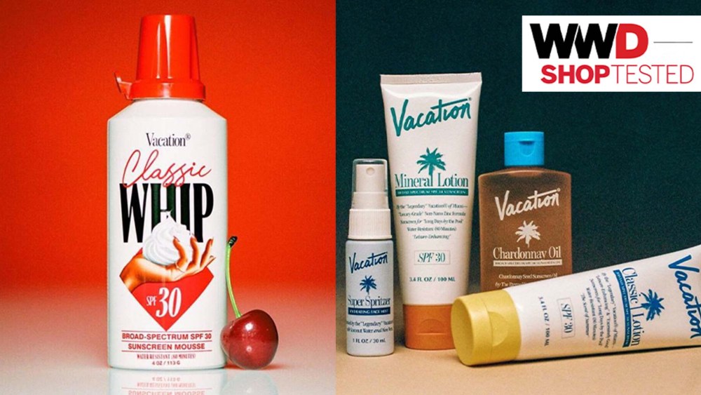 red and white whipped sunscreen bottle with cherry on red background; various sunscreen products resting on a table