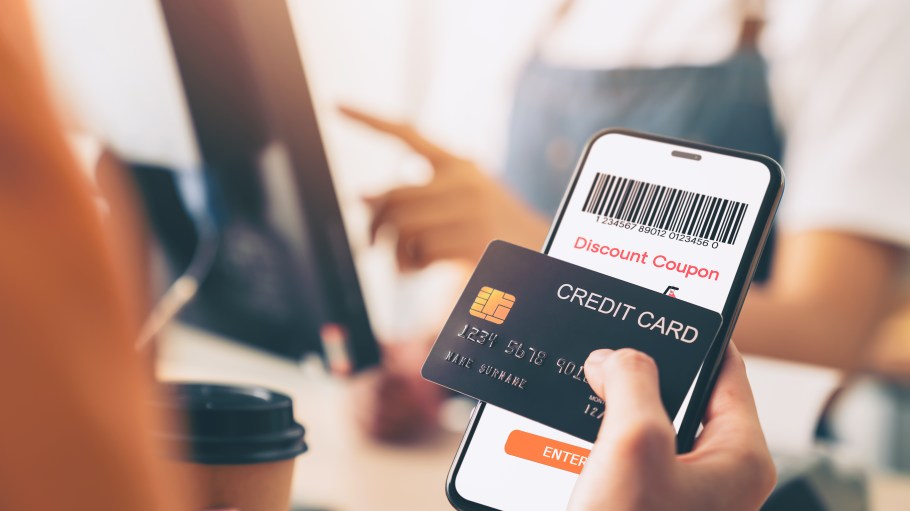 Hand holding credit card payment and using smartphone with scan barcode for discount code coupon, shopping online, Digital wallet concept.