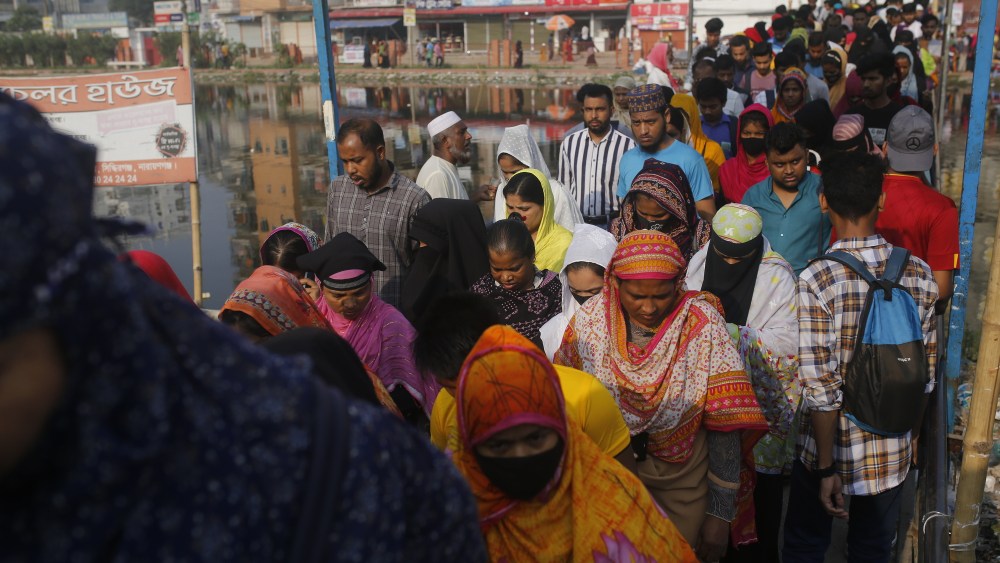 Garment Workers In Bangladesh
Garment workers are crossing a bridge while going to the factories in Narayanganj, Bangladesh, on May 16, 2024. (Photo by Rehman Asad/NurPhoto via Getty Images)