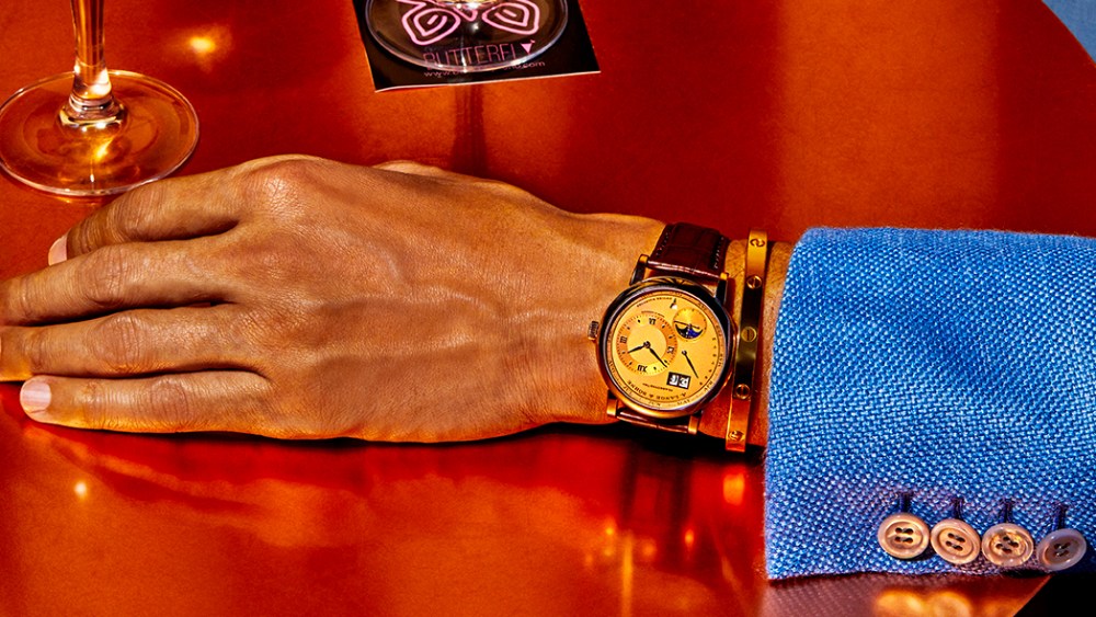 An A. Lange & Söhne Perpetual Calendar, white gold case with solid gold pink dial watch. Brioni silk jacket; Cartier Love 18-karat yellow gold bracelet. Buckeye drink.