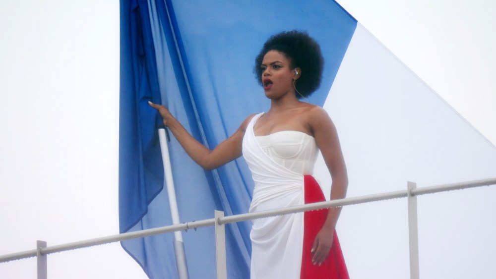 Axelle Saint-Cirel sings the French national anthem on the roof of the Grand Palais wearing a draped Dior dress in the colors of the French flag during the opening ceremony of the 2024 Paris Olympics on July 26.