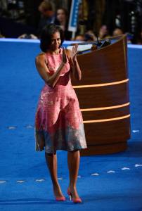 CHARLOTTE, NC - SEPTEMBER 04:  First lady Michelle Obama claps after she exits the stage after speaking during day one of the Democratic National Convention at Time Warner Cable Arena on September 4, 2012 in Charlotte, North Carolina. The DNC that will run through September 7, will nominate U.S. President Barack Obama as the Democratic presidential candidate.  (Photo by Kevork Djansezian/Getty Images)