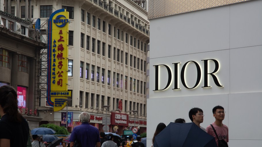 Shoppers walk past a Dior storefront in Shanghai.