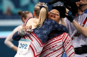 Jordan Chiles of Team United States reacts with Jade Carey of Team United States after competing on the uneven bars during the Artistic Gymnastics Women's Team Final on day four of the Olympic Games Paris 2024 at Bercy Arena on July 30, 2024 in Paris, France.