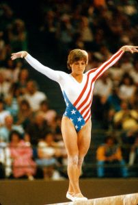 LOS ANGELES, CA - CIRCA 1984: Gymnast Mary Lou Retton of the United States competes in the balance beam competition in gymnastics during the Games of the XXIII Olympiad in the 1984 Summer Olympics circa 1984 at UCLA's Pauley Pavilion in Los Angeles, California. (Photo by Focus on Sport/Getty Images)