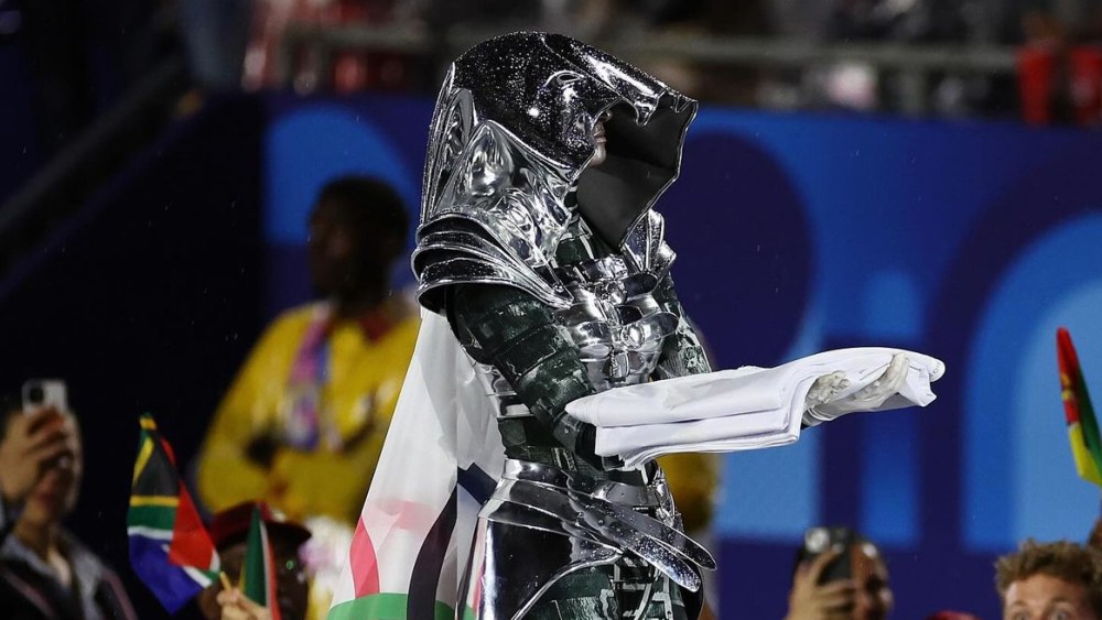 A rider dressed in a Jeanne Friot outfit delivers the Olympic flag during the opening ceremony of the 2024 Paris Olympic Games