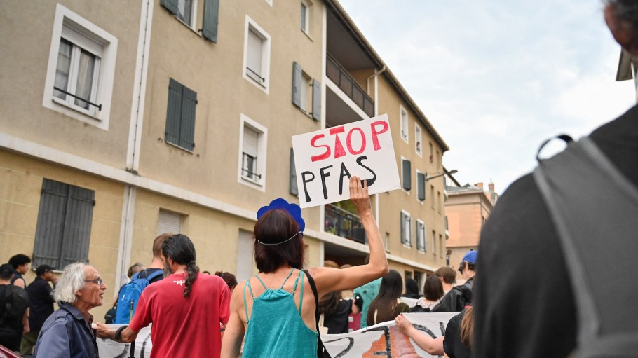 A demonstrator holds up a placard with "STOP PFAS" written on it during a demonstration against the use of the eternal pollutant PFAS in Oullins, France.