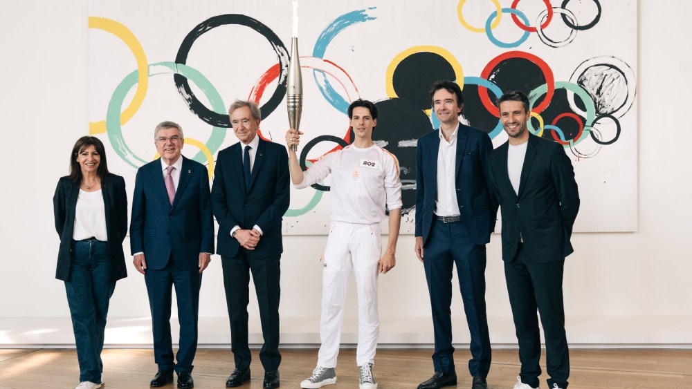 Paris Mayor Anne Hidalgo; president of the Olympic Committee Thomas Bach; LVMH chief Bernard Arnault; Paris Opera Ballet principal dancer Germain Louvet; LVMH’s head of communication, image, and environment Antoine Arnault, and Tony Estanguet, chief of the Olympics’ Organizing Committee.
