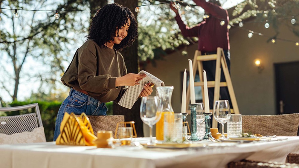 woman arranging dining table for outdoors event