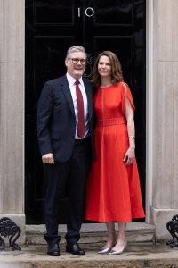 Labour leader and incoming Prime Minister Sir Keir Starmer and wife Victoria pose for the press as they enter 10 Downing Street following Labour's landslide election victory on July 5, 2024 in London, England. The Labour Party won a landslide victory in the 2024 general election, ending 14 years of Conservative government.
