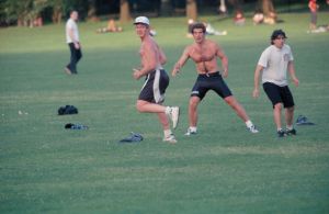 John F. Kennedy Jr. playing frisbee in Central Park with his friend Robert Littell.