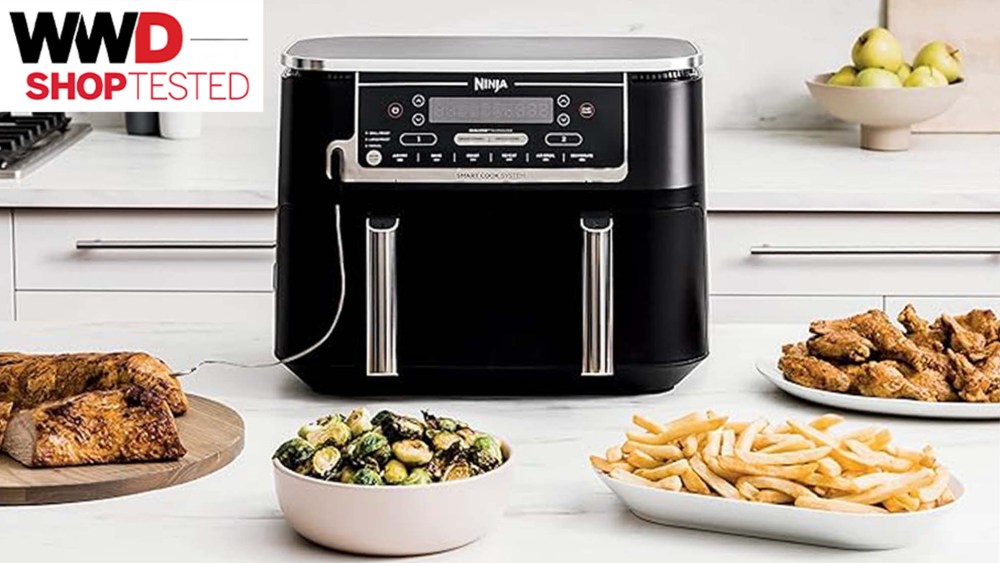 air fryer on kitchen counter with plates of food