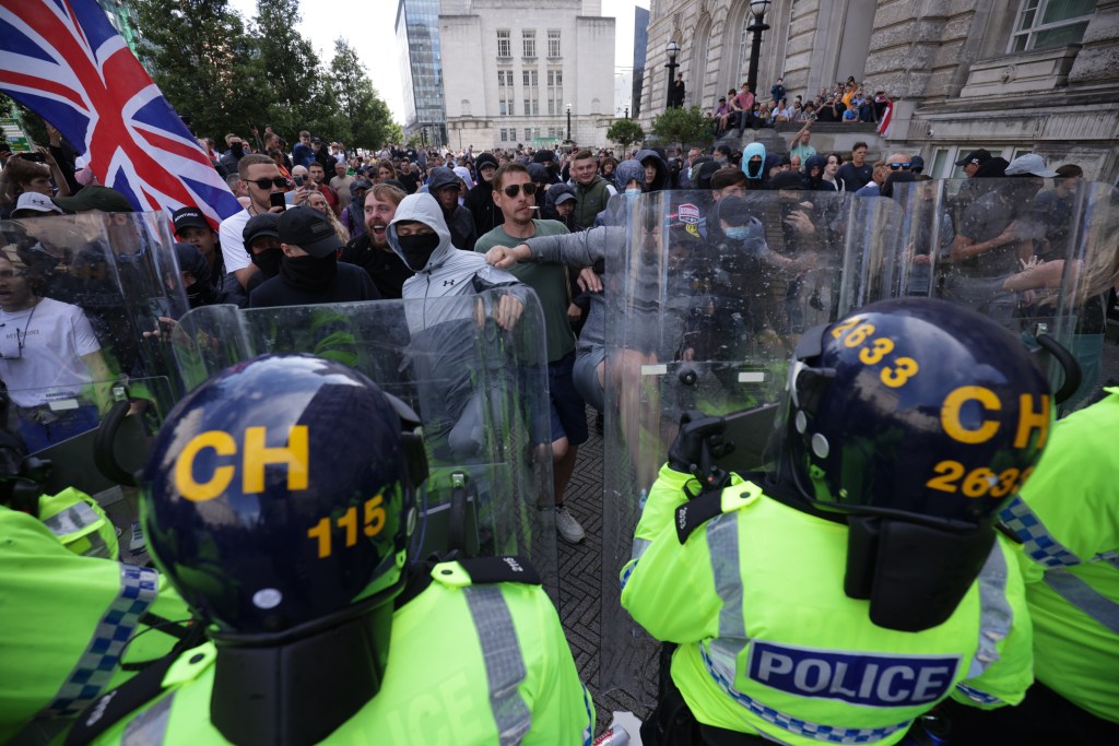 Police officers face protesters in Liverpool, following the stabbing attacks on Monday in Southport, in which three young children were killed. Picture date: Saturday August 3, 2024. (Photo by James Speakman/PA Images via Getty Images)