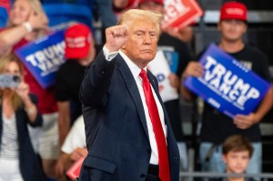 Former President and current Republican presidential nominee Donald Trump raises his fist as he leaves the stage during a campaign event on Saturday, August 3, 2024 in Atlanta, GA.