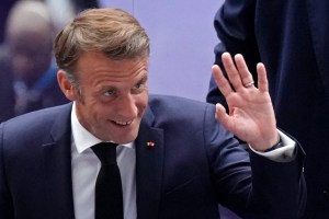 France's President Emmanuel Macron waves as he arrives for the closing ceremony of the Paris 2024 Olympic Games at the Stade de France, in Saint-Denis, in the outskirts of Paris, on August 11, 2024.