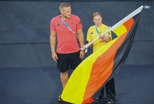 German flag bearers Laura Lindemann and Max Rendschmidt stand in the Stade de France during the closing ceremony in Paris.