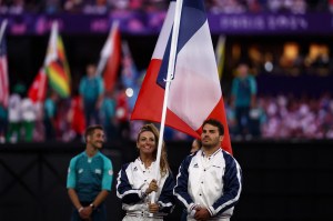 France's rugby player Antoine Dupont and France's cyclist Pauline Ferrand-Prevot wave the French national flag during the closing ceremony of the Paris 2024 Olympic Games at the Stade de France, in Saint-Denis, in the outskirts of Paris, on August 11, 2024.