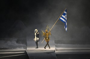 A performer holds Greece's flag during the closing ceremony of the Paris 2024 Olympic Games at the Stade de France, in Saint-Denis, in the outskirts of Paris, on August 11, 2024.
