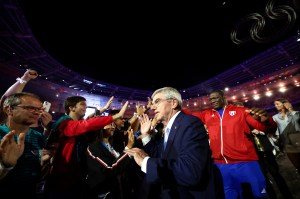 International Olympic Committe (IOC) President Thomas Bach is greeted by athletes as he leaves at the end of the closing ceremony of the Paris 2024 Olympic Games at the Stade de France, in Saint-Denis, in the outskirts of Paris, on August 11, 2024.