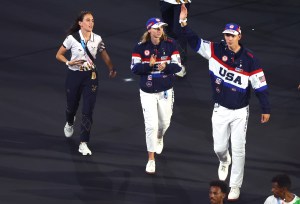Flagbearers Katie Ledecky and Nick Mead wave of Team United States of America walk during the Closing Ceremony of the Olympic Games Paris 2024 at Stade de France on August 11, 2024 in Paris, France.
