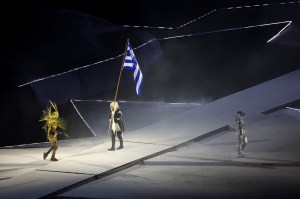 The Horsewoman prepares to pass the national flag of Greece to The Golden Voyager as a light show takes place during the Closing Ceremony of the Olympic Games Paris 2024 at Stade de France on August 11, 2024 in Paris, France.