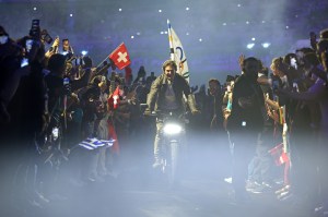 American Actor and Film Producer Tom Cruise rides on a Motorbike with the IOC Flag during the Closing Ceremony of the Olympic Games Paris 2024 at Stade de France on August 11, 2024 in Paris, France.